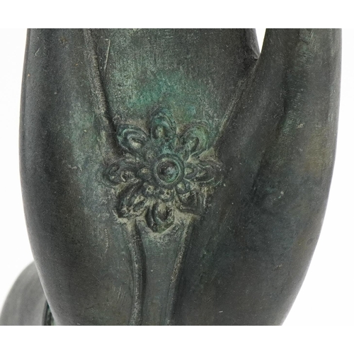 497 - Thai verdigris patinated bronze hand raised on an ebonised stand, overall 32.5cm high