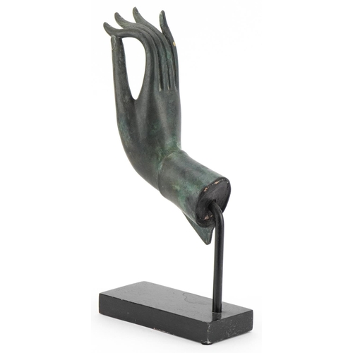 497 - Thai verdigris patinated bronze hand raised on an ebonised stand, overall 32.5cm high