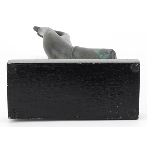 497 - Thai verdigris patinated bronze hand raised on an ebonised stand, overall 32.5cm high