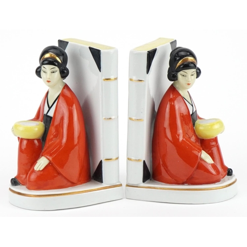 1760 - Pair of Art Deco style figural bookends of Asians females beside books, each 16cm high