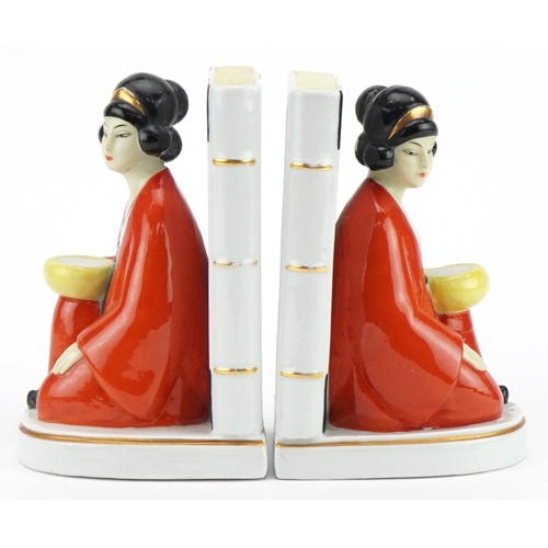 1760 - Pair of Art Deco style figural bookends of Asians females beside books, each 16cm high