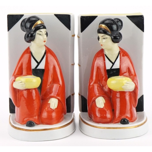 1760 - Pair of Art Deco style figural bookends of Asians females beside books, each 16cm high