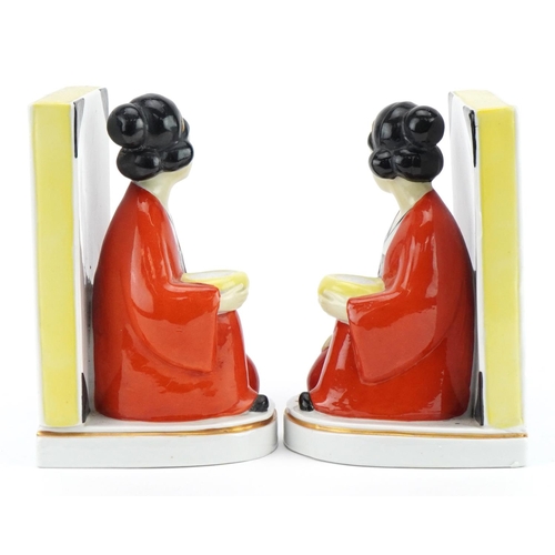 1760 - Pair of Art Deco style figural bookends of Asians females beside books, each 16cm high