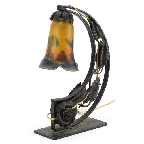 Hollywood Regency style iron arch design naturalistic table lamp with frilled glass shade, the glass shade indistinctly signed, 36cm high