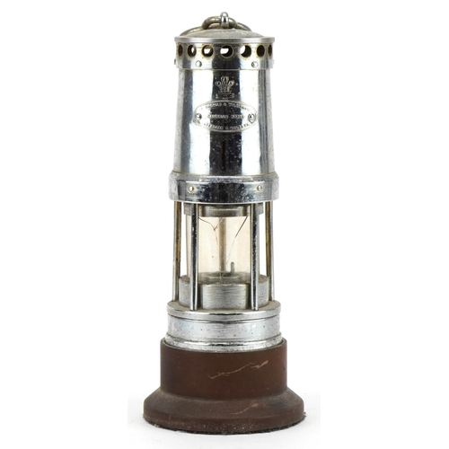 Chrome plated E Thomas & Williams Cambrian Works miner's lamp with fleur de lis on hardwood stand, overall 20cm high