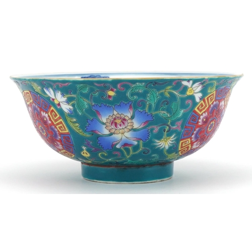 1414 - Chinese Tibetan porcelain turquoise ground footed bowl hand painted with flower heads amongst scroll... 