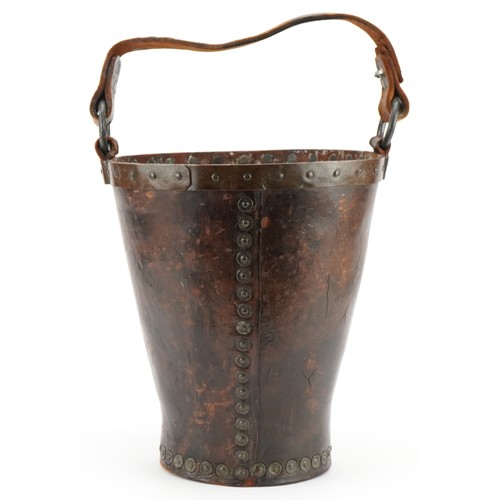 92 - 19th century military interest metal studded leather fire bucket impressed WD 64, 31cm high excludin... 