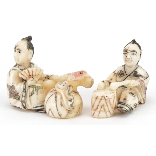 1766 - Two Japanese carved bone netsukes including a one of a drummer, the largest 5.5cm wide