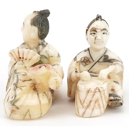 1766 - Two Japanese carved bone netsukes including a one of a drummer, the largest 5.5cm wide