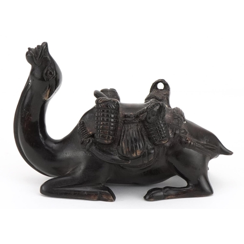 1704 - Patinated bronze recumbent camel with saddle bag, 19cm in length