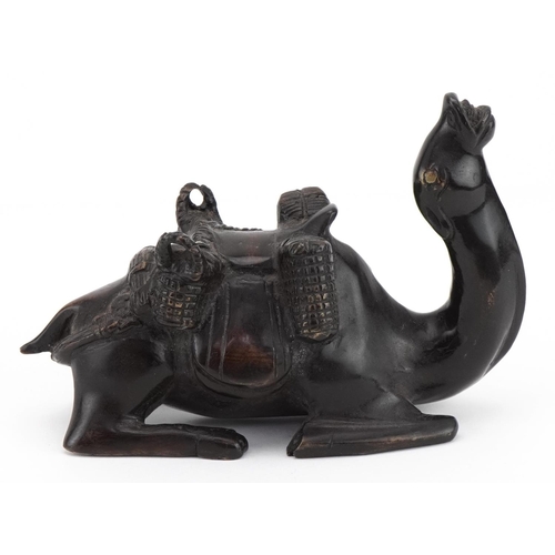 1704 - Patinated bronze recumbent camel with saddle bag, 19cm in length