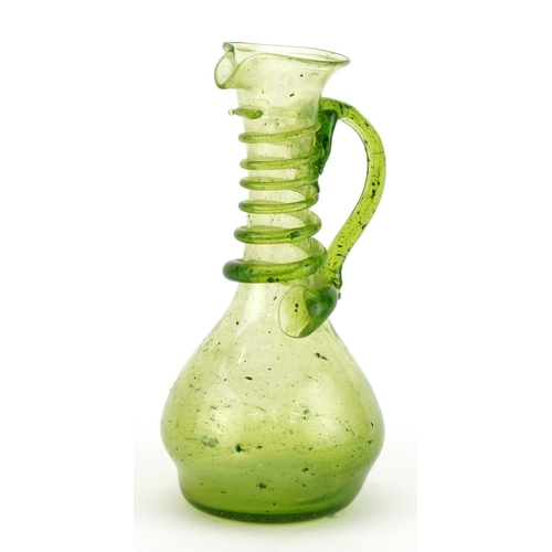 1744 - Roman style green glass ewer with trailed decoration, 15cm high