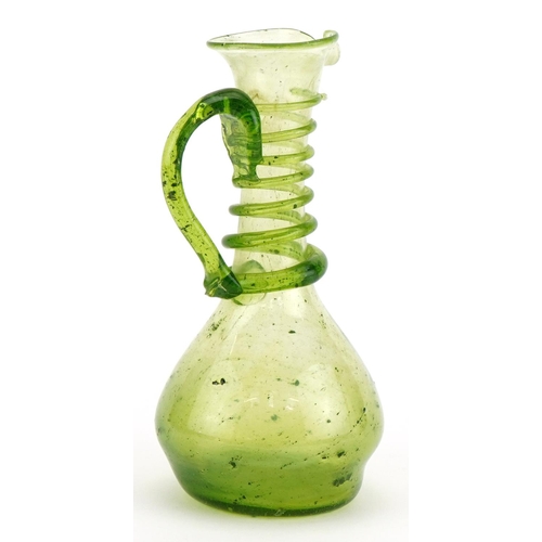 1744 - Roman style green glass ewer with trailed decoration, 15cm high