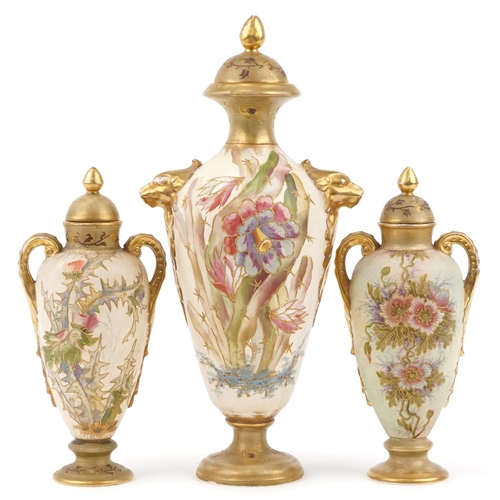 1702 - Royal Bonn, garniture of three blush ivory vases and covers with handles, each decorated with flower... 