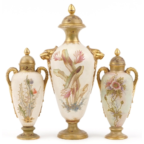 1702 - Royal Bonn, garniture of three blush ivory vases and covers with handles, each decorated with flower... 