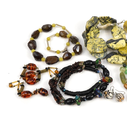 2554 - Six polished stone and glass bead necklaces and a pair of earrings including agate and jade