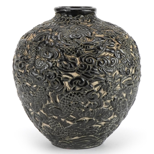 541 - Chinese porcelain vase having a black glaze profusely decorated in relief with dragons amongst cloud... 