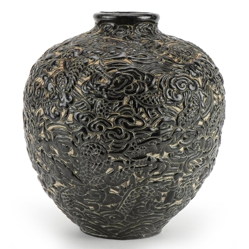 541 - Chinese porcelain vase having a black glaze profusely decorated in relief with dragons amongst cloud... 