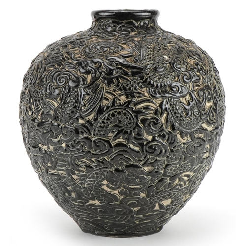 541 - Chinese porcelain vase having a black glaze profusely decorated in relief with dragons amongst cloud... 