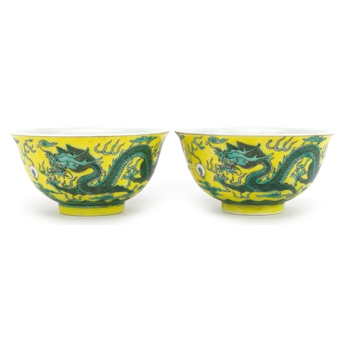 546 - Pair of Chinese yellow ground porcelain bowls hand painted with dragons chasing the flaming pearl am... 