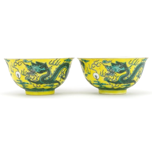 546 - Pair of Chinese yellow ground porcelain bowls hand painted with dragons chasing the flaming pearl am... 