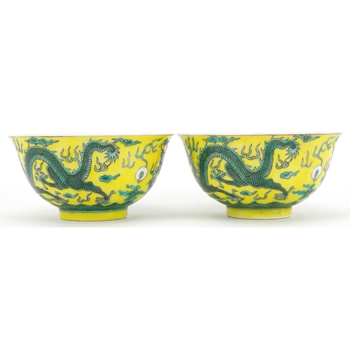 546 - Pair of Chinese yellow ground porcelain bowls hand painted with dragons chasing the flaming pearl am... 