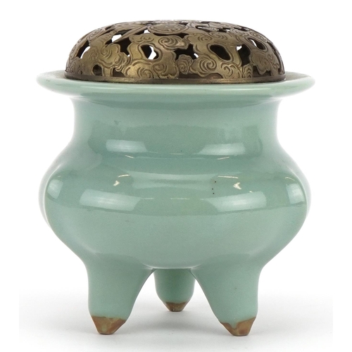 516 - Chinese porcelain tripod censer having a celadon glaze with pierced white metal lid, 10.5cm high