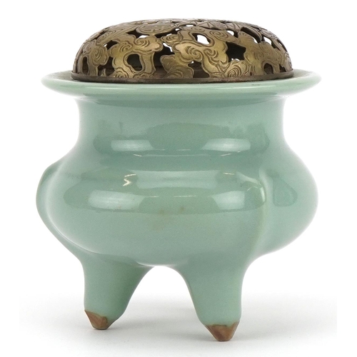 516 - Chinese porcelain tripod censer having a celadon glaze with pierced white metal lid, 10.5cm high