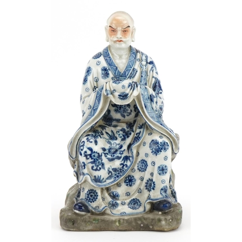 417 - Chinese porcelain figure of an emperor wearing a blue and white robe, hand painted with flower heads... 