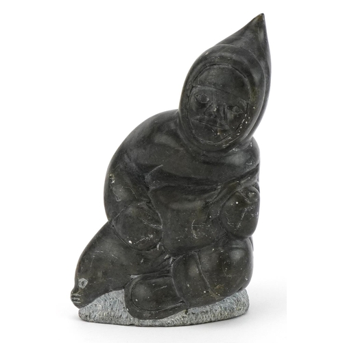 493A - Inuit hardstone carving of an Eskimo, incised marks and paper label to the base, 15cm high