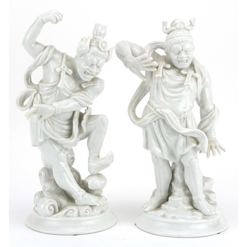 1705 - Pair of Fitz & Floyd porcelain figures of Chinese warriors having blanc de chine glazes, 30.5cm high