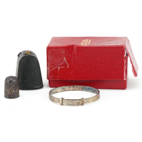 1618 - Engine turned silver christening bracelet and silver thimble housed in a fitted leather case, the ch... 