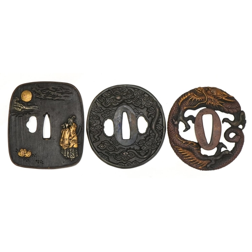 467 - Three Japanese iron tsubas including a mixed metal example cast in low relief with a female playing ... 