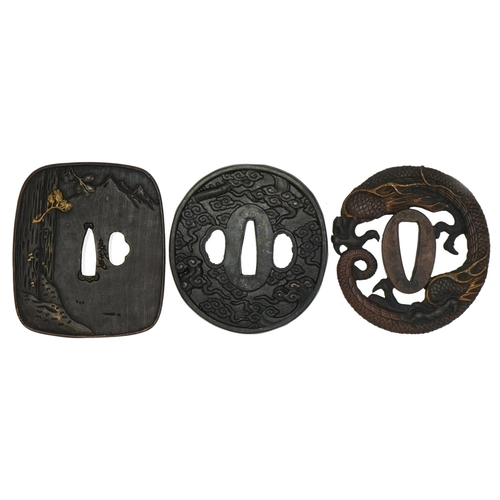 467 - Three Japanese iron tsubas including a mixed metal example cast in low relief with a female playing ... 