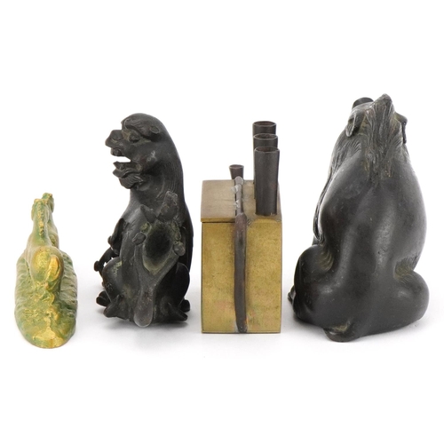 521 - Chinese metalware including a patinated bronze Foo dog and brass teapot, the largest 13cm in length