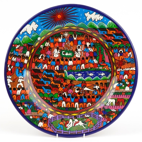 1746 - South American pottery charger hand painted with village life, 41cm in diameter