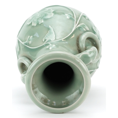 1534 - Chinese porcelain vase with elephant head ring turned handles having a celadon glaze decorated in lo... 