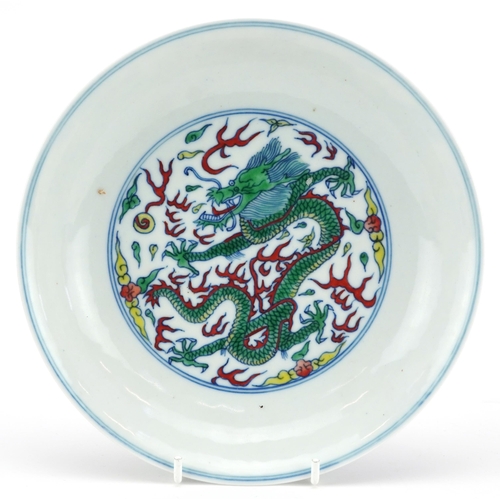 1765 - Chinese porcelain doucai dish hand painted with dragons amongst clouds, six figure character marks t... 