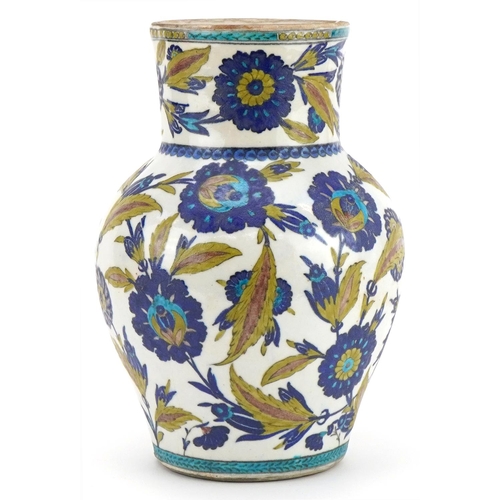 265 - Islamic pottery vase hand painted with stylised flowers and foliage, 28cm high