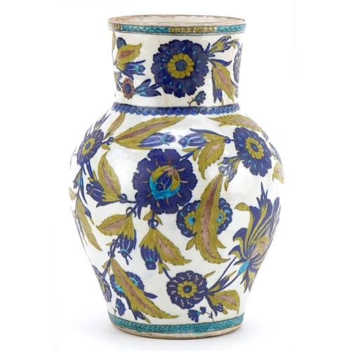 265 - Islamic pottery vase hand painted with stylised flowers and foliage, 28cm high