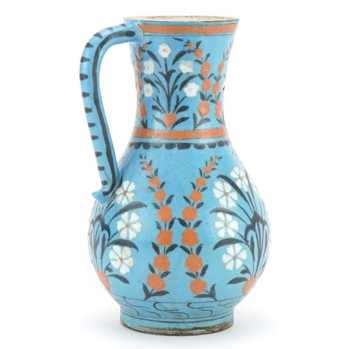 148 - Iznik pottery water jug hand painted with flowers, 24cm high