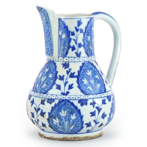 264 - Islamic pottery water jug hand painted with stylised leaves, 21cm high