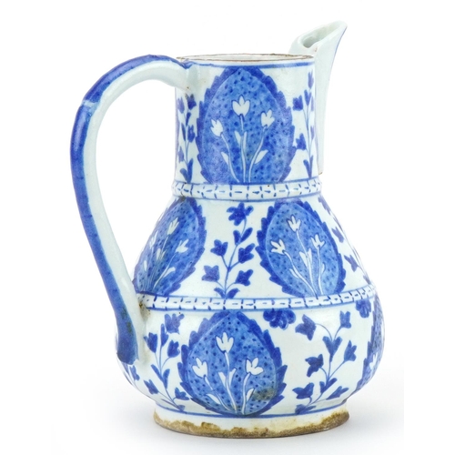 264 - Islamic pottery water jug hand painted with stylised leaves, 21cm high