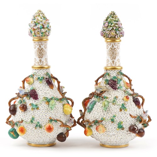 40 - Meissen, large pair of 19th century German floral encrusted bottles with stoppers decorated in relie... 