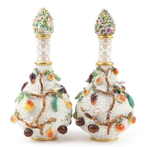 40 - Meissen, large pair of 19th century German floral encrusted bottles with stoppers decorated in relie... 