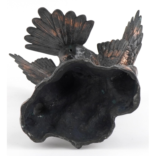 1697 - Bronzed cast metal study of an eagle perched on a rock, 44cm high