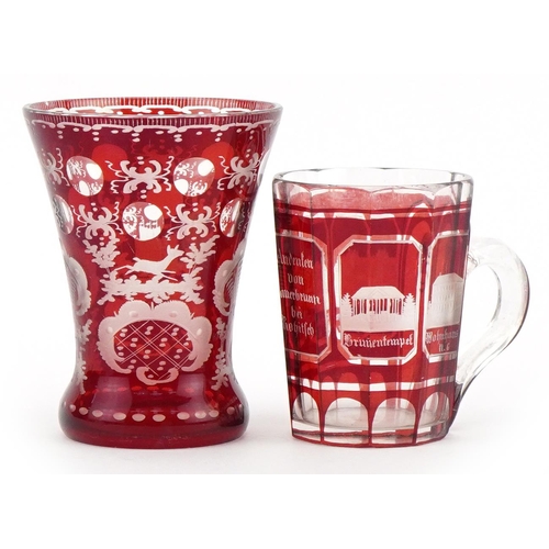 479 - Bohemian ruby overlaid glass vase and mug etched with German towns, the largest 13cm high