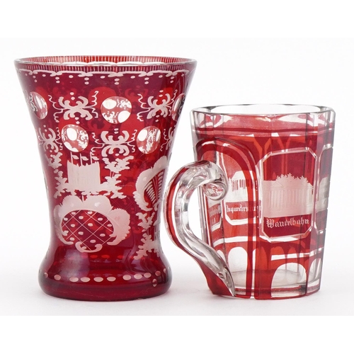 479 - Bohemian ruby overlaid glass vase and mug etched with German towns, the largest 13cm high