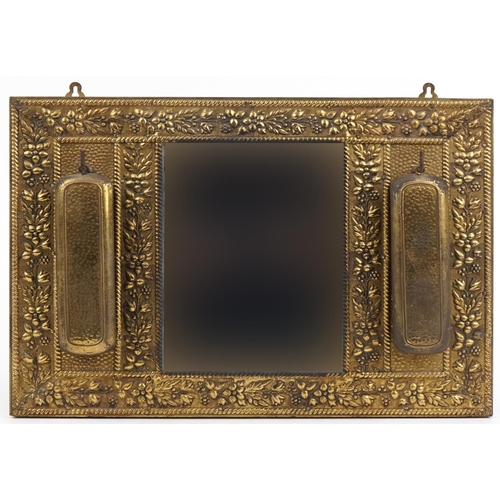 1655 - Vintage embossed brass hall mirror with two clothes brushes, 43cm x 32cm