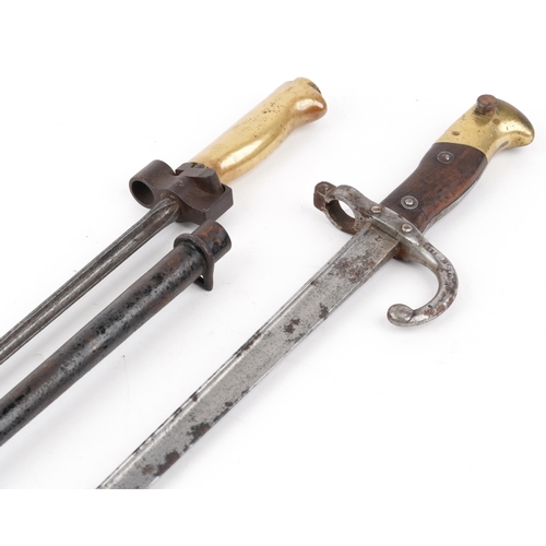 704 - Two military interest bayonets including a French example, 65.5cm in length